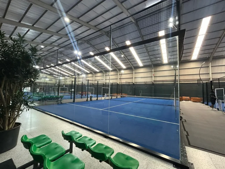 Indoor panoramic court and courtside seating at Arturf Padel Arena