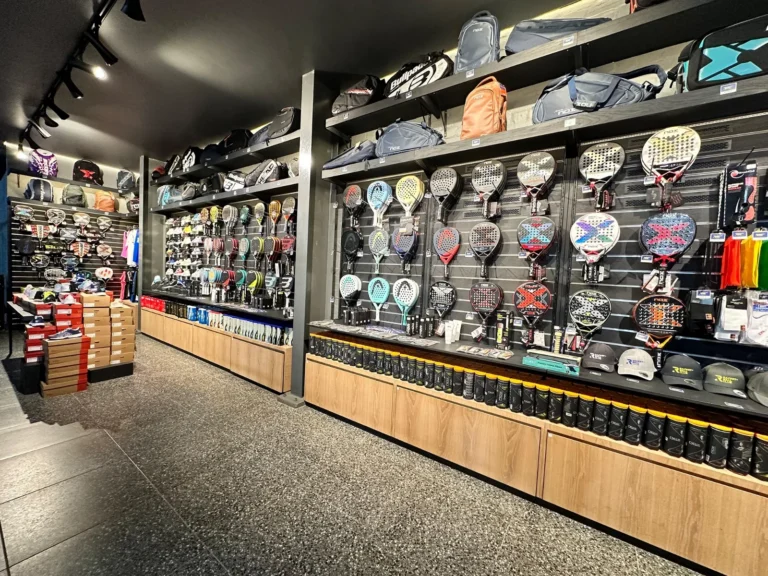 Wall of padel rackets in the pro shop at The Racket + Ball Club Bree Street