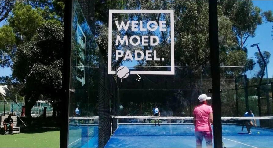 Welgemoed Padel sign on the glass of a blue padel court