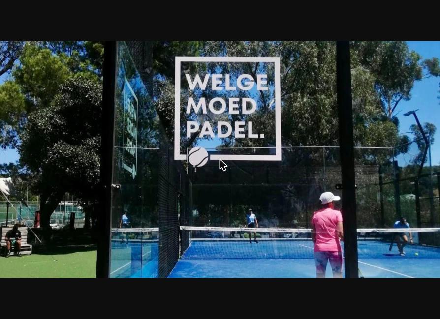 Players on court behind the Welgemoed Padel sign